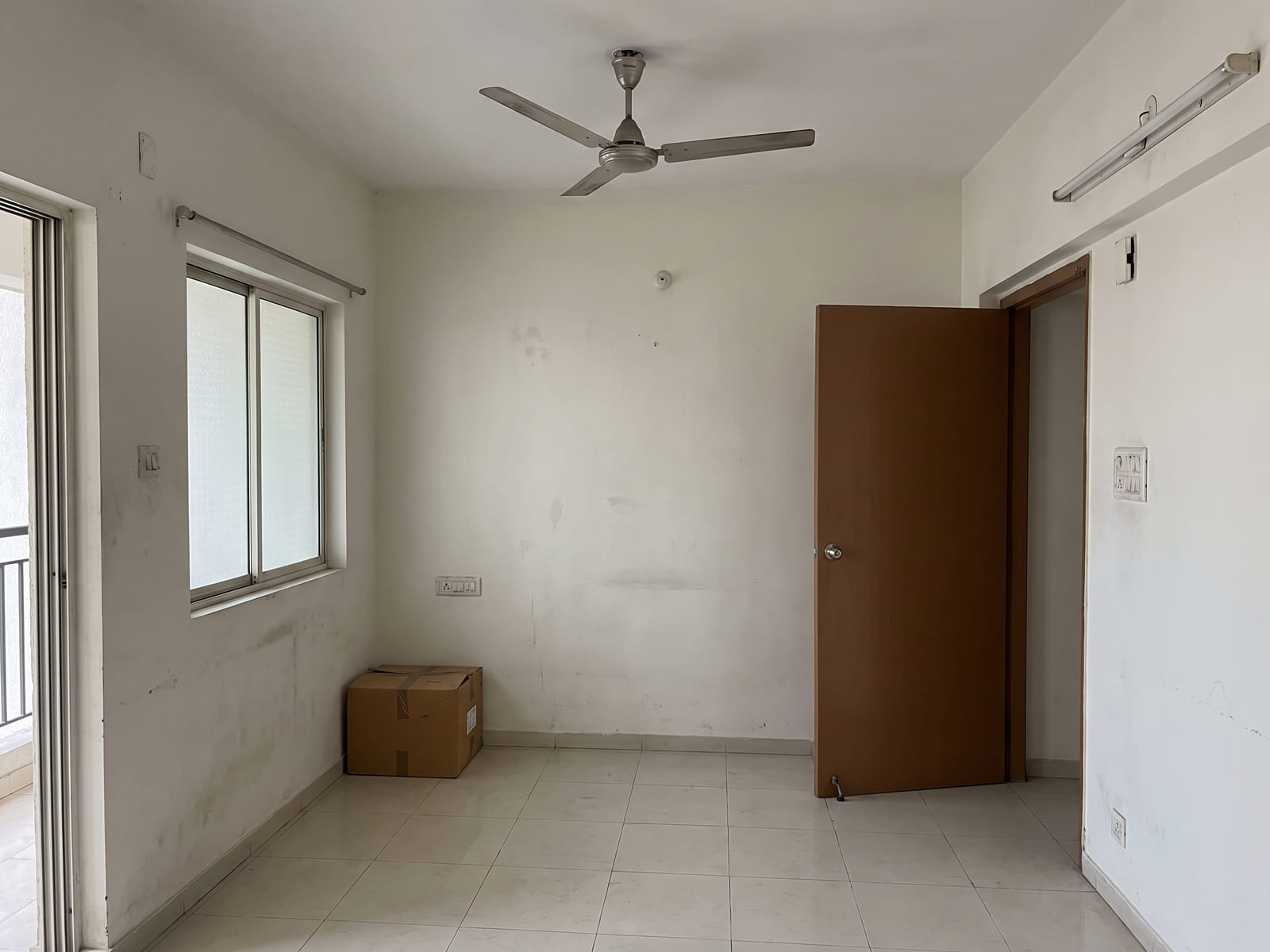 Living room before design — a bare Indian apartment room